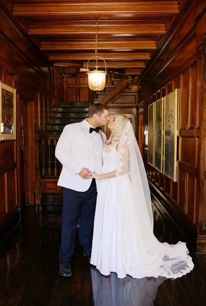 A couple in the cypress-paneled stair hall at 11 Mile.