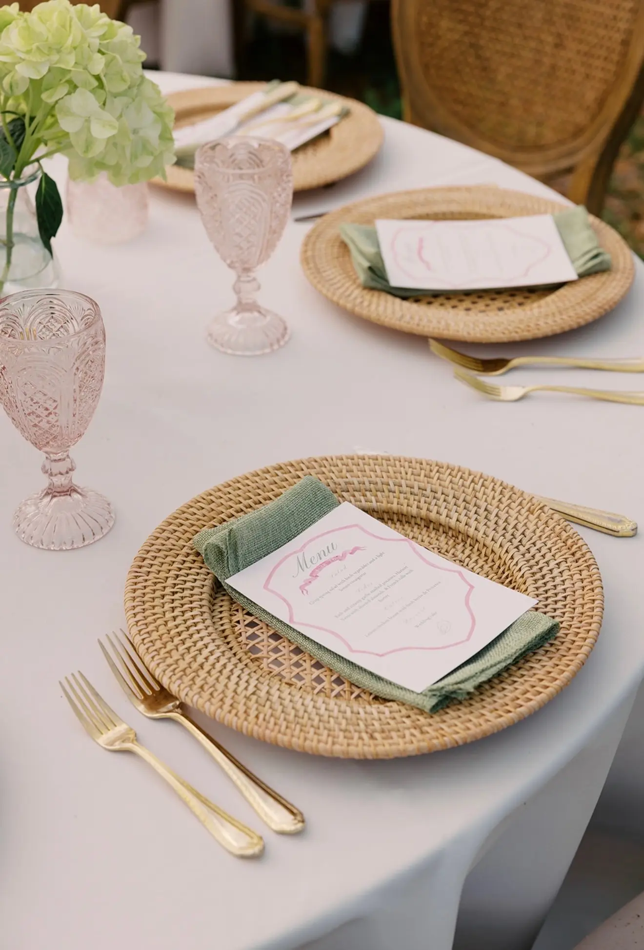 A place setting at 11 Mile with a rattan charger, linen napkin and cut glass.